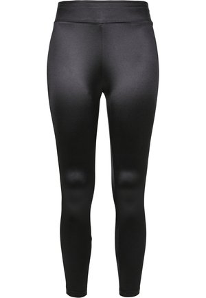 Sorte leggings med et glatt, elastisk stoff og høy livlinje. Tett til kroppen design strekker seg til anklene. Ingen synlig maskinvare eller mønstre.