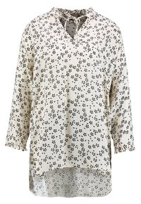 Kevyt, kerma värinen paita mustalla kukkakuviolla, V-neulauksella ja nauhoilla, 3/4-hihat ja röyhelö cuffit, sisältää korkea-matala helman.