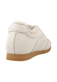 White suede sneaker with a textured finish, shearling lining around the collar, and a beige rubber sole. Features decorative stitching.