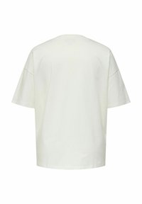 Camiseta de algodón de color beige claro, de corte oversized, con mangas cortas, cuello redondo y una textura suave. La vista trasera muestra un diseño simple y sin adornos.