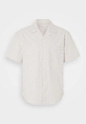 Short-sleeve button-up shirt in light beige with vertical dark stripes, featuring a chest pocket and a fold-down collar.