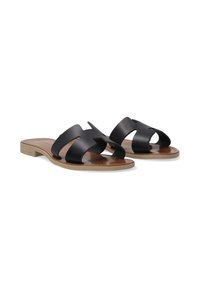 Schwarze Leder-Sandalen mit Schnittmuster, sandfarbiger Innensohle und flacher Sohle. Sie verfügen über eine glatte Textur und eine minimalistische Form.