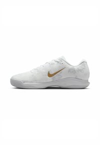 Weißer Sportschuh mit strukturiertem Obermaterial, ausgestattet mit einem goldenen Nike-Swoosh, Schnürdesign, runder Zehenpartie und flexibler Gummisohle.