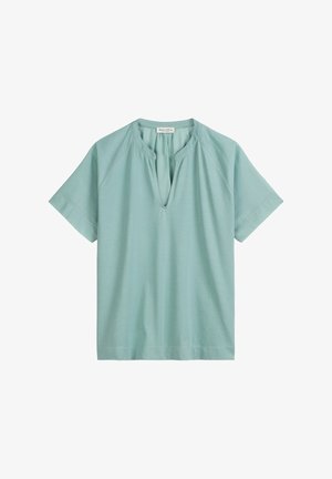 Lichtblauwe top met korte mouwen van een zachte, gladde stof met een relaxte pasvorm en een V-hals. Beschikt over raglanmouwen en een rechte zoom.