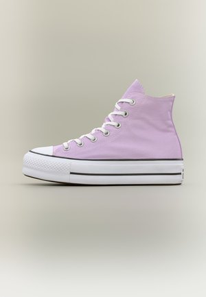 Lilac high-top canvas sneaker with white rubber sole and toe cap, white laces, and metal eyelets on a neutral background.