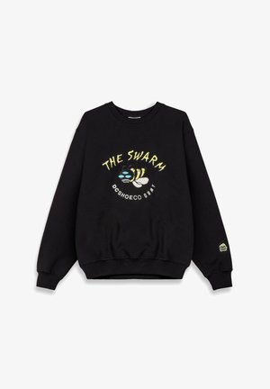 Czarny sweatshirt z okrągłym dekoltem, długimi rękawami i ściągaczami. Na przodzie graficzny motyw przedstawia stylizowaną pszczołę oraz tekst "THE SWARM."