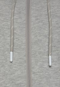 Light gray hooded sweatshirt featuring a full zipper, braided drawstrings, and smooth texture. Includes white plastic tips on drawstrings.