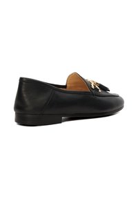 Black leather loafer with low heel, tan interior lining, and gold tassel detail on upper, shown in side view on white background.