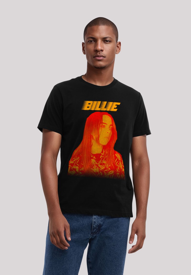Black cotton t-shirt featuring a large orange-red graphic of a person with long hair and the text "BILLIE" above. Casual fit, crew neck.