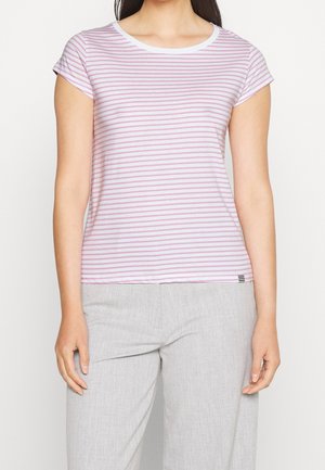 Woman wearing a short-sleeve, white and pink horizontal striped shirt paired with light gray pants, standing against a plain background.