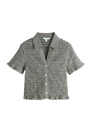 Short-sleeve button-up shirt in black and white checkered pattern. Features smocked texture and a ruffled hem. Made from lightweight fabric.