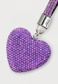 Purple heart-shaped keychain adorned with small, sparkling rhinestones. Metallic clasp and ribbon feature matching purple accents.