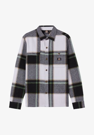 Flannel shirt featuring a black, white, and green plaid pattern, long sleeves, a button-up front, and a chest pocket with a logo patch.