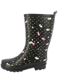 Bottes de pluie en caoutchouc noir imperméables avec des pois blancs et des motifs floraux en rose et blanc. Elles disposent d'une semelle texturée et d'un haut revers.