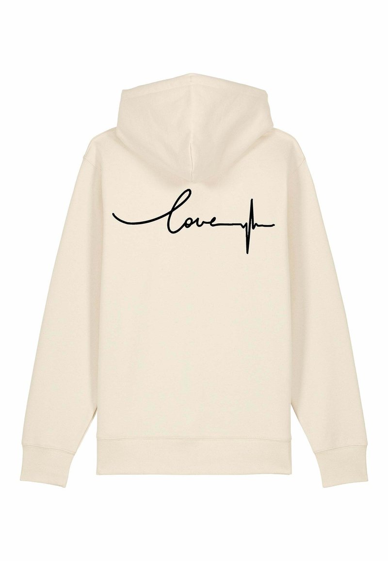 Krem dukserica s crnim kurzivnim natpisom "love" i dizajnom linije srčanog otkucaja na leđima. Mekana tkanina, kapuljača s vezicom i rebrasti rukavi.
