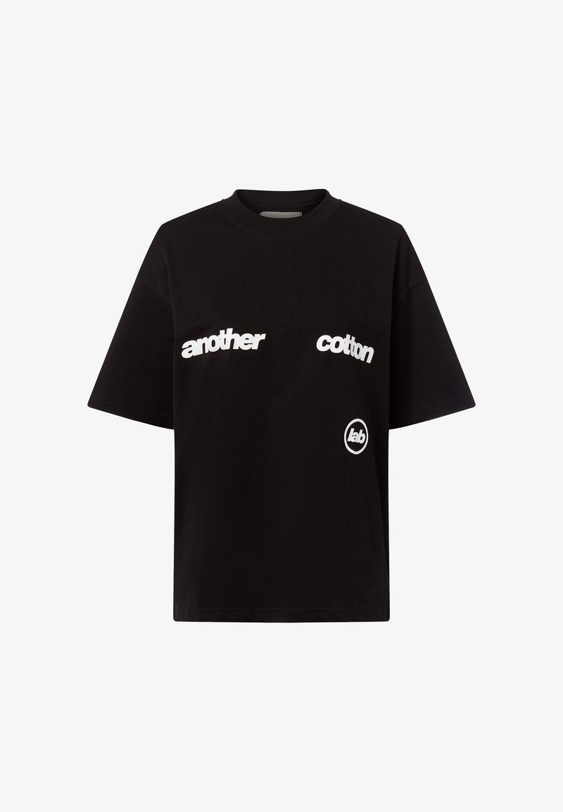 Black cotton t-shirt featuring white text "another" and "cotton" across the chest, with a circular logo on the bottom right. Classic fit.