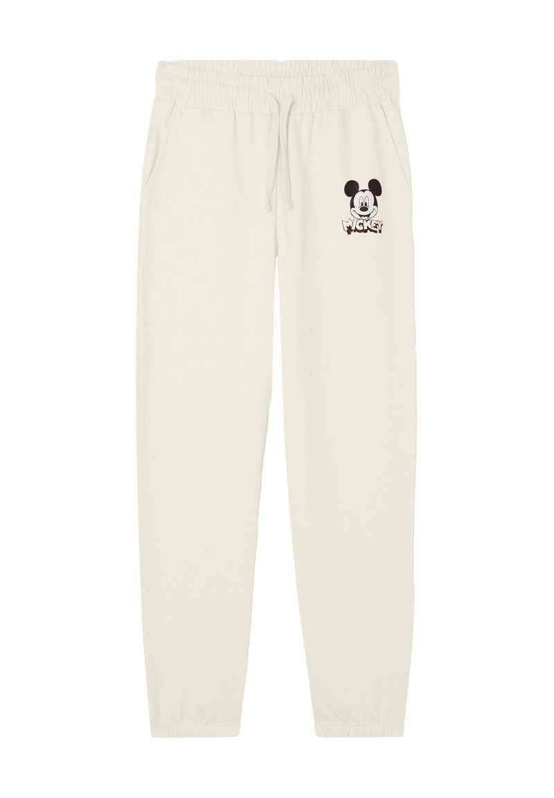 Pantaloni della tuta color crema con vita elastica, tasche laterali e una piccola grafica di Topolino sulla gamba sinistra. Tessuto morbido.