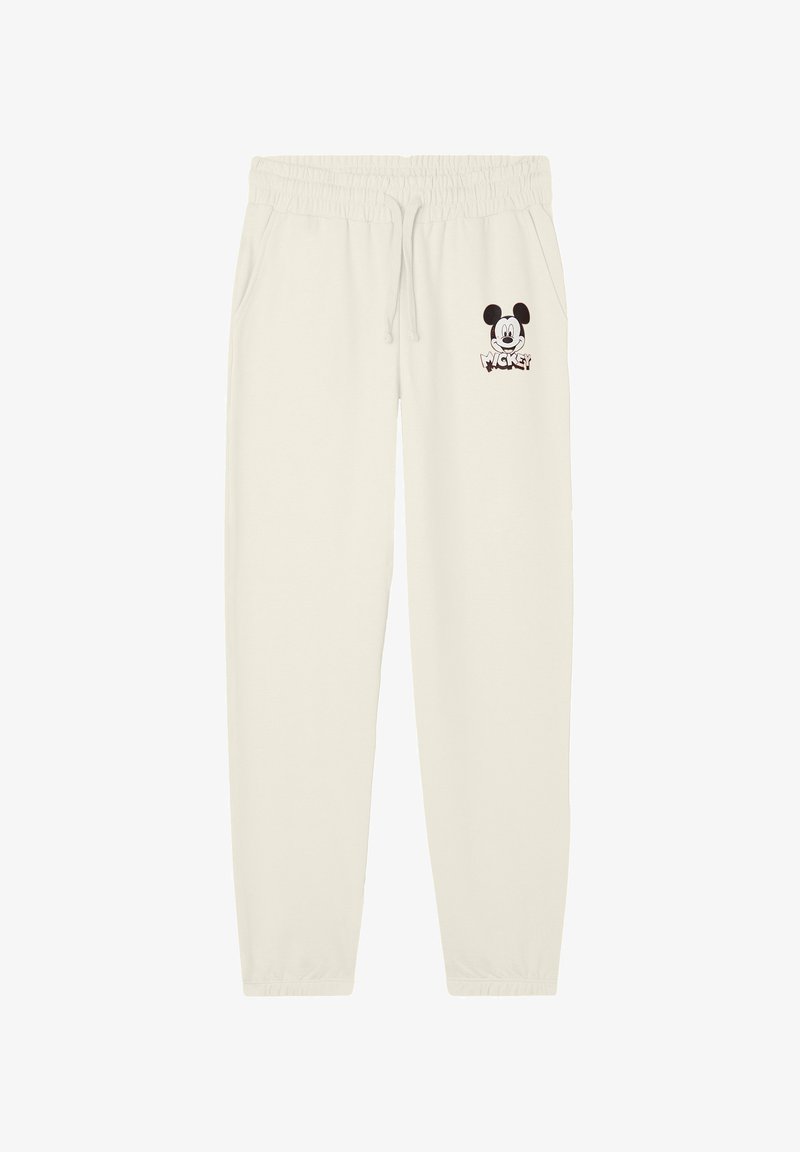 Pantaloni della tuta color crema con vita elastica, tasche laterali e una piccola grafica di Topolino sulla gamba sinistra. Tessuto morbido.