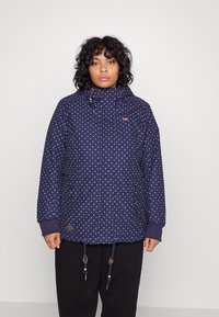Navy polka dot jacket with a hood, featuring elastic cuffs and adjustable drawstrings, detailed with brown accents and front pockets.