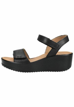 Sort læder kilehæl sandal med justerbare stropper omkring ankel og forfod, beige indersål og tekstureret ydersål for bedre greb.