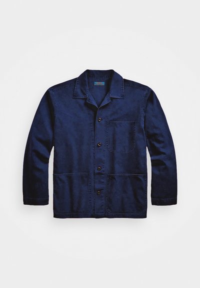 Mornarsko modra jakna iz denima, ki ima ovratnik, sprednje gumbe, žep na prsih in dva spodnja žepa s kontrastnim šivanjem.