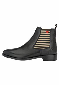 Bottines en cuir noir avec des panneaux élastiques rayés beige et noir, un petit détail en forme de cœur rouge et un petit talon carré.