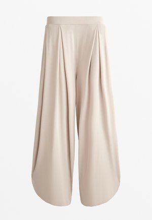 Pantalons larges en beige, légers, avec une taille haute et un design plissé. Texture lisse avec des ourlets arrondis en bas.