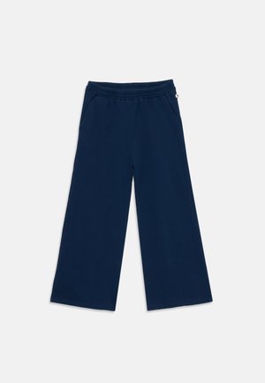 Námornícke modré nohavice s širokými nohavicami, elastickým pásom a bočnými vreckami, položené na bielom pozadí.