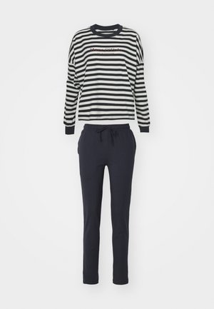 Randig långärmad topp i svart och vitt med rund halsringning och marinblå byxor med snörning. Mjuk tyg, avslappnad passform och elastisk midja.
