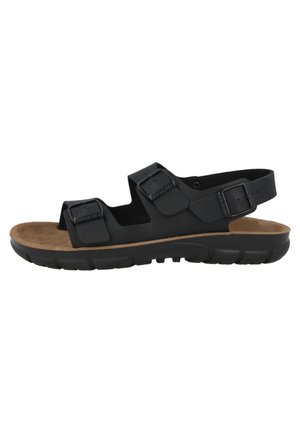 Black sandal with two adjustable straps, cork footbed, and a textured rubber sole. Features a minimalist design for comfort and support.