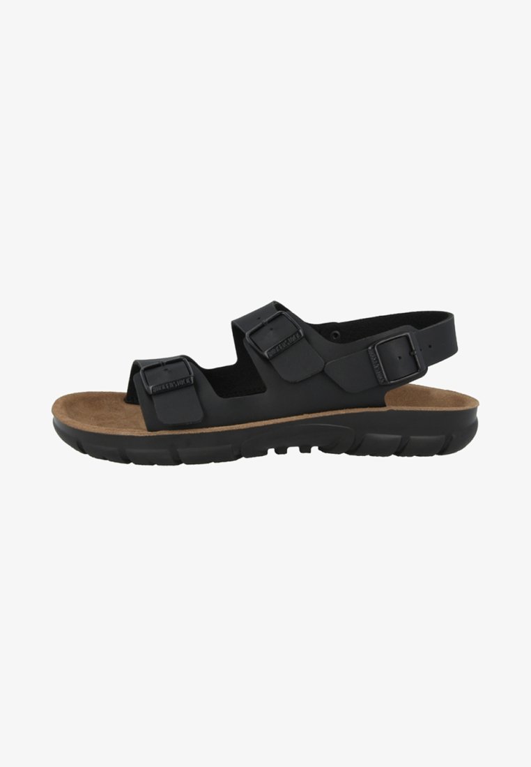 Black sandal with two adjustable straps, cork footbed, and a textured rubber sole. Features a minimalist design for comfort and support.