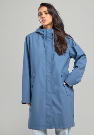 Veste imperméable bleue avec capuche, boutons-pression, poches latérales et manches longues. Texture lisse, conception longueur genou avec caractéristiques réglables.