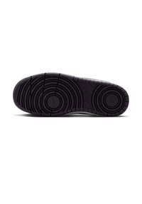 Suola di scarpa in gomma nera con motivi circolari concentrici e scanalature per la trazione. Superficie strutturata con dettaglio del marchio vicino al tallone.