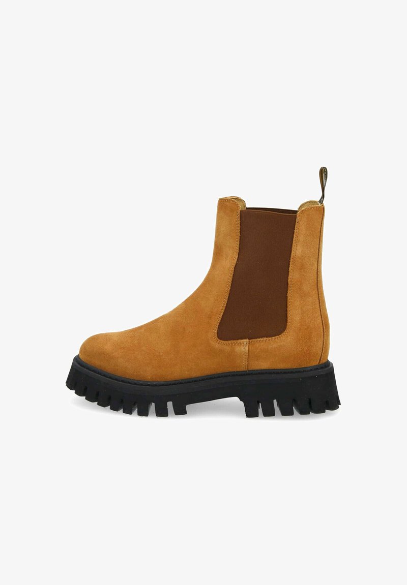 Brown suede Chelsea boot with elastic side panels, round toe, and thick black textured sole. Features a pull tab at the heel for easy wear.