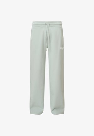 Pantalones de chándal de algodón verde claro con cintura elástica, cordón, bolsillos laterales y un pequeño logotipo en el muslo izquierdo.