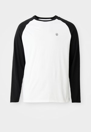 Long-sleeve T-shirt with a white body and black raglan sleeves. Features a small logo on the chest. Made of cotton.
