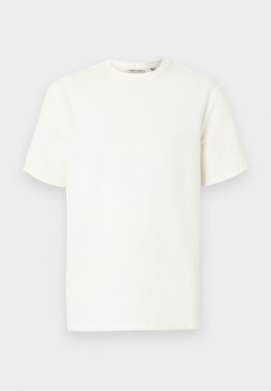 T-shirt blanc uni à manches courtes, col rond, coupe régulière et tissu subtilement texturé, présenté sur un fond clair.