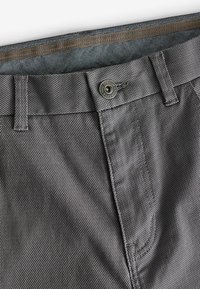 Grå vævede shorts med et struktureret stof, knaplukning og forstærkede syninger. Inkluderer et mønstret inderfor.