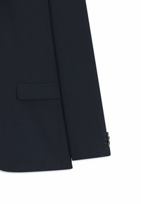 Blazer bleu marine en tissu texturé, avec une poche poitrine simple et des poignets à double bouton. Coupe ajustée avec épaules structurées.