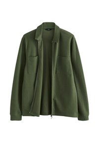 Chaqueta con cremallera en verde oscuro, confeccionada en un tejido texturizado, con cuello plano y dos bolsillos frontales. Presenta un diseño relajado y puños acanalados.