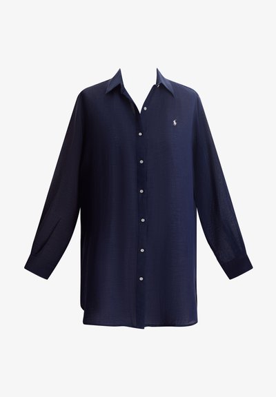 Könnyű anyagból készült tengerészkék ing, elöl gombolós, hosszú ujjú, kis logóval a mellkason.