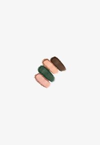Four smudged eyeshadow swatches in matte shades of pink, green, peach, and brown on a white background.