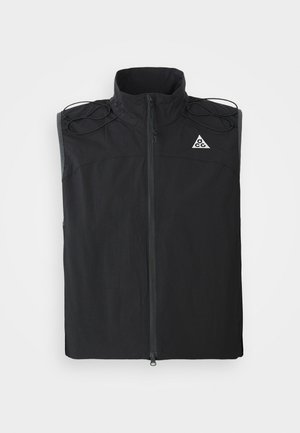 Black sleeveless vest made of lightweight fabric. Features a high collar, front zipper, and drawstring accents on the shoulders.