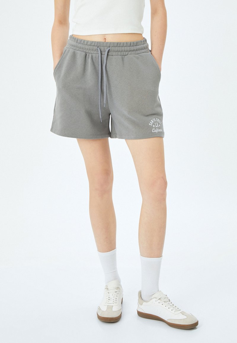 Grijze katoenen blend shorts met een elastische tailleband en trekkoord, met zijzakken en een witte logo-print op de linker dij.