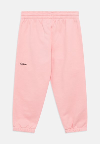 Pantalones jogger de color rosa claro, fabricados con un tejido suave, que cuentan con una cintura y puños elásticos, además de un pequeño logotipo negro en una pierna.