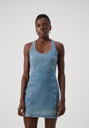 Denim dress in light blue with a fitted silhouette, racerback design, visible stitching, and a hemline above mid-thigh.