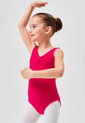Fuchsia leotard with a v-neck and short sleeves, featuring a ruched detail at the center. Paired with white leggings.