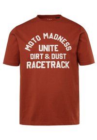 Rust-colored cotton t-shirt with short sleeves and a crew neckline. Features bold white text: "MOTO MADNESS UNITE DIRT & DUST RACETRACK."