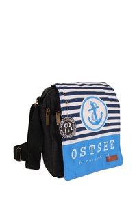 Black messenger bag with blue and white striped flap, featuring an anchor graphic, brand tag, and leather accent. Zippered closure and adjustable strap.