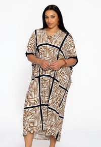 Robe maxi à motifs marron et blanc, avec un décolleté en V, des manches courtes et de larges bords noirs. Comprend un accent rond au niveau du col.